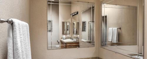 a bathroom with a large mirror and a sink at PVC at The Roundhouse Resort in Pinetop-Lakeside