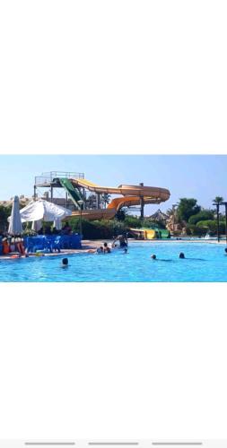 a water park with a water slide in the water at Chalet in Mena 4 in Dawwār ‘Abd al ‘Aţī Abū ‘Ajūz