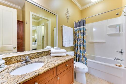 a bathroom with a sink and a tub and a toilet at Lovely Baton Rouge Condo about 1 Mi to LSU in Baton Rouge