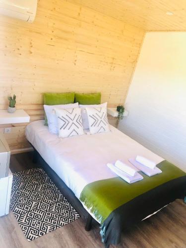 a bedroom with a bed with two towels on it at Varzea Nature in Torres Vedras