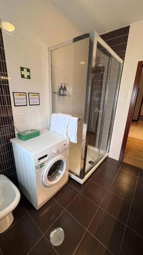 a bathroom with a washing machine and a shower at S. Mamede House - Penafiel in Recezinhos