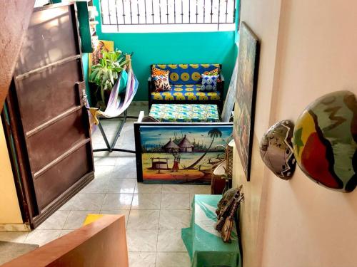 a hallway of a room with a couch and a window at Fadidi House in Dakar