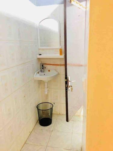 a bathroom with a sink and a mirror at Fadidi House in Dakar