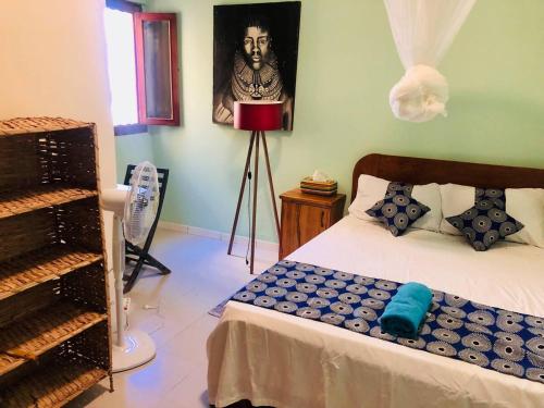 a bedroom with a bed and a lamp in it at Fadidi House in Dakar