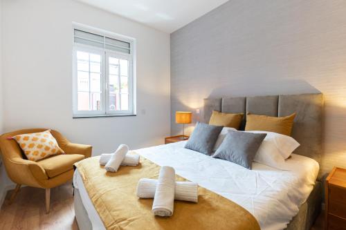 a bedroom with a large bed and a chair at Best House Center - with Garage in Porto