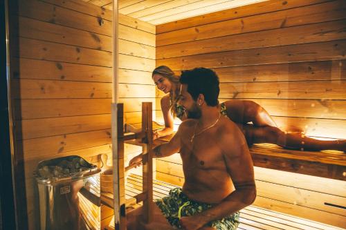two men are standing in a sauna at Eksōtika in Oliveri