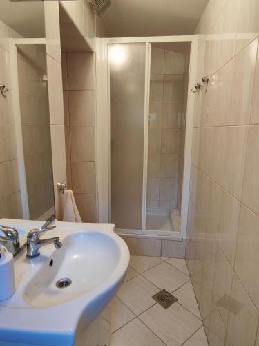a bathroom with a sink and a shower at Holiday house Panorama in Ozalj