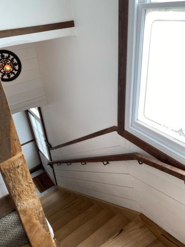 a tiny house with a staircase and a window at Duart Stables in Maffra