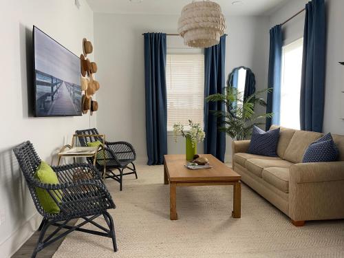 a living room with a couch and a table at New! Stylish 1900s Renovated Duplex Apartment Building Near Forsyth & River St in Savannah