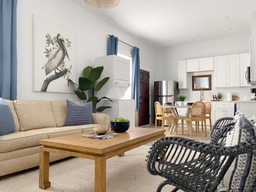 a living room with a couch and a table at New! Stylish 1900s Renovated Duplex Apartment Building Near Forsyth & River St in Savannah