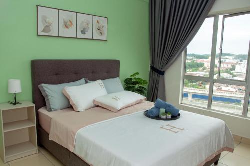 a bedroom with a bed and a large window at Five H Family Service Apartment in Seri Kembangan