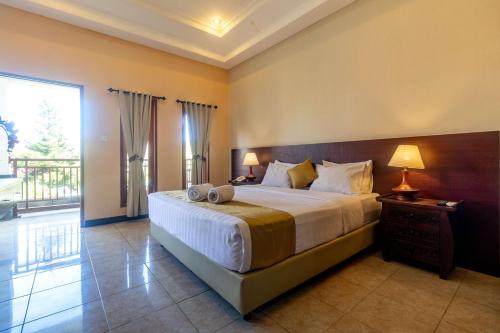 Postel nebo postele na pokoji v ubytování Segara Agung Boutique Hotel