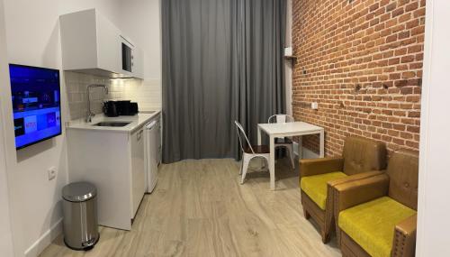 a kitchen with a couch and a table in a room at Brand NEW Studio Centro, Atocha - Museums in Madrid