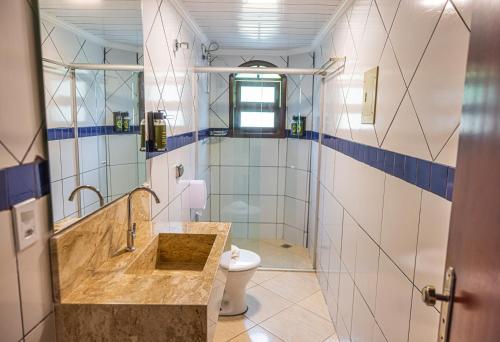 a bathroom with a sink and a toilet at Ubatuba Eco Hotel in Ubatuba