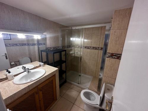 a bathroom with a sink and a shower and a toilet at Vista Hermosa in Portals Nous