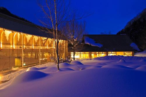 a building in the snow at night at Bettei Senjyuan in Minakami