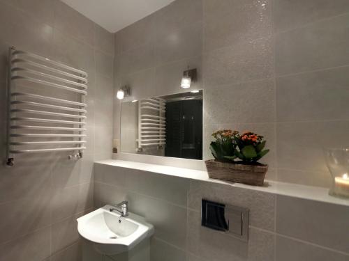 a bathroom with a sink and a mirror and a toilet at Sopot Baltic in Sopot