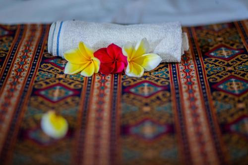 two felt flowers sitting on top of a table at Pondok Raamshanti Lembongan in Nusa Lembongan