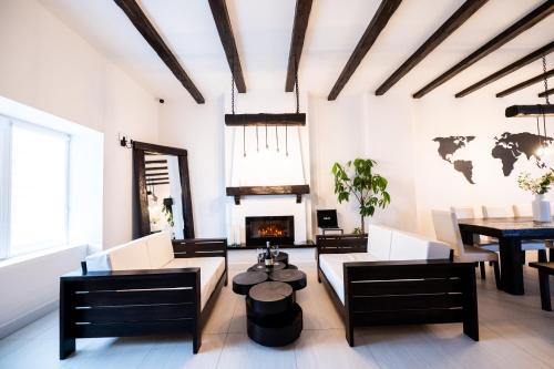 a living room with a table and a fireplace at Casa Bolta Rece in Sighetu Marmaţiei