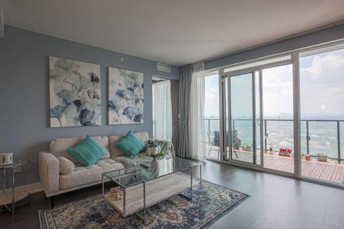 a living room with a couch and a glass table at Luxury view in Toronto Downtown 3 Bedroom 2.5 Bathroom 1 Parking in Toronto