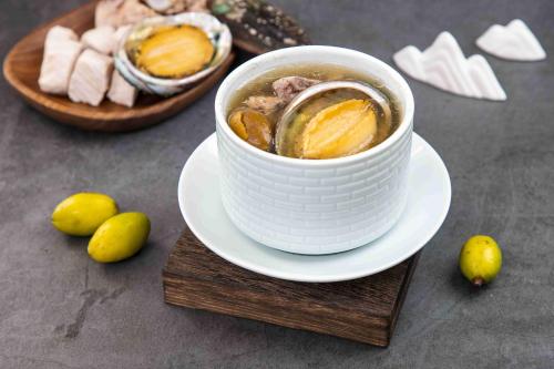 a cup of soup on a plate on a table at Guangzhou Wogo Yuanbao Hotel-Zhujiang New Town-Free Canton Fair Shuttle Bus & Overseas Buyer Registration Services in Guangzhou