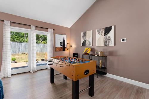 a room with a foosball table in the middle at The Sinatra - Fun 5BD Home Huge Pool Game Room in Round Rock