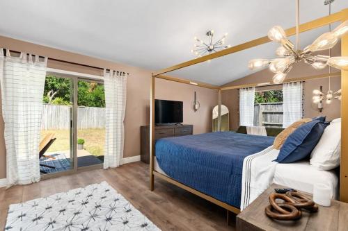 a bedroom with a bed with a blue comforter at The Sinatra - Fun 5BD Home Huge Pool Game Room in Round Rock