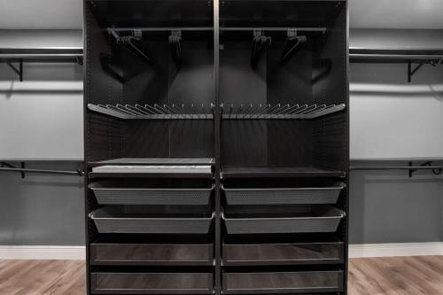 a black refrigerator with empty shelves in a room at The Sinatra - Fun 5BD Home Huge Pool Game Room in Round Rock