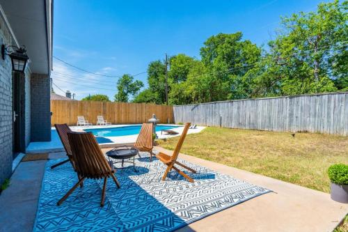 a patio with two chairs and a pool at The Sinatra - Fun 5BD Home Huge Pool Game Room in Round Rock
