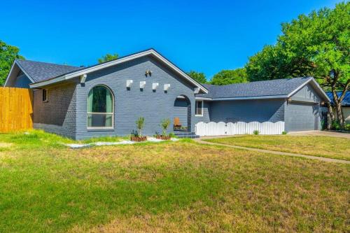 a gray house with a white fence in a yard at The Sinatra - Fun 5BD Home Huge Pool Game Room in Round Rock