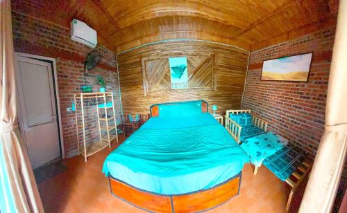 a small room with a bed in a brick wall at D&D riverside Homestay in Xuân Sơn