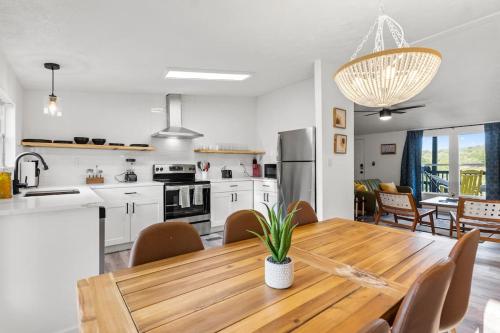 a kitchen and dining room with a wooden table at Starlight Horizon Cabin M - Pet-Friendly Texas Hill Country Cabin Near Canyon Lake - Pool, Stargazing & Group Getaways - Sleeps 8 in Canyon Lake