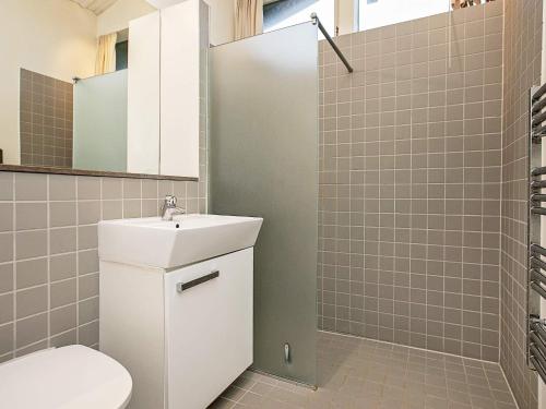 a bathroom with a toilet and a sink and a shower at Holiday home Gilleleje XV in Gilleleje