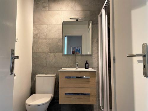 a bathroom with a toilet and a sink and a mirror at Appartement Morzine, 2 pièces, 4 personnes - FR-1-754-53 in Morzine