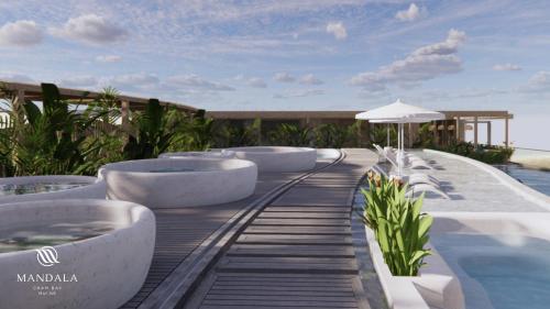 a resort with a train track next to a swimming pool at M Continental by Mandala Mui Ne in Phan Thiet
