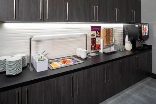 a kitchen with a counter with plates and food at Residence Inn by Marriott Tulsa Downtown in Tulsa