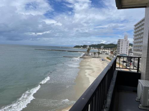 a view of the beach from the balcony of a building at Support Inn Minami-Chita Annex Hamachaya in Minamichita