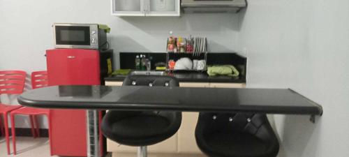 a table and chairs in a room with a kitchen at Place to stay in Manila