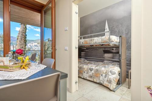 a dining room with a table and a bunk bed at CallaLillyJardin in Malcesine