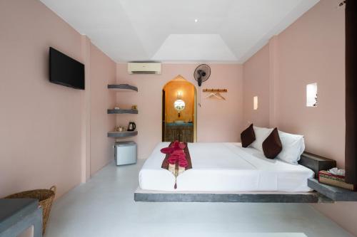 a bedroom with a white bed in a room with pink walls at Avocado Koh Samui in Bophut 