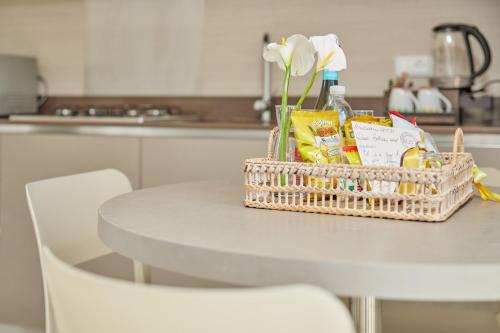 a basket of groceries sitting on a table in a kitchen at CallaLillyJardin in Malcesine