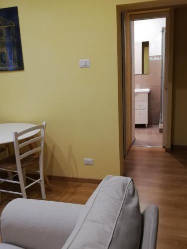 a living room with a table and a chair at Candelieri Suites in Sassari