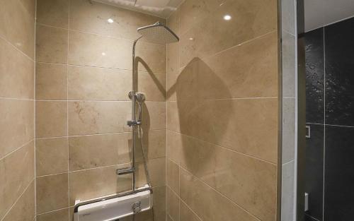a shower with a glass door in a bathroom at Hotel Grand Bay Boryeong in Boryeong