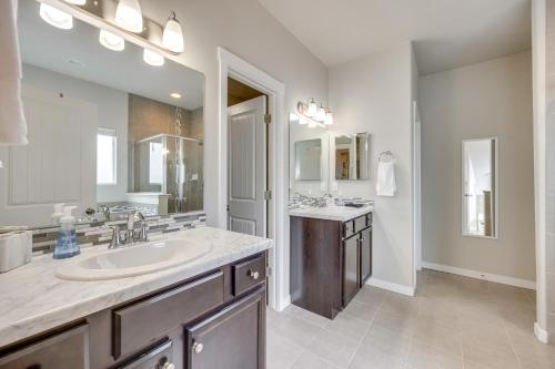 a bathroom with a sink and a large mirror at Stunning Peyton Retreat with Game Room, Private Yard in Shirley
