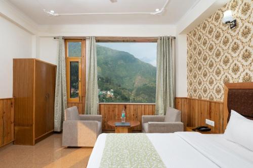 a hotel room with a bed and a large window at Vella Marina Group of hotels Mcleodgunj in Dharamshala