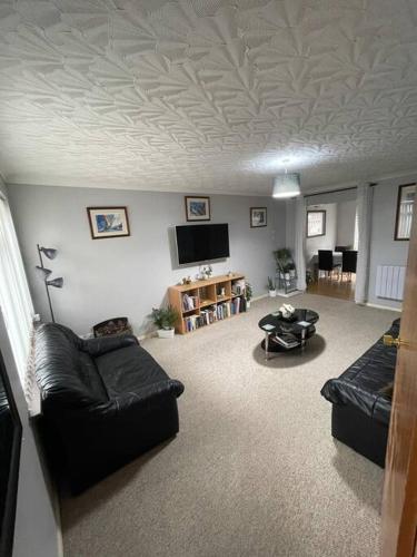 a living room with a couch and a tv at Harbour view in Cowes