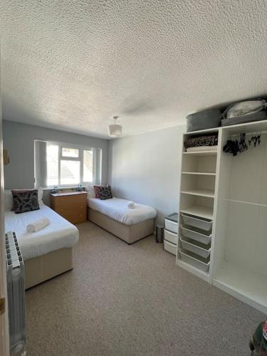 a bedroom with two beds and a window in it at Harbour view in Cowes