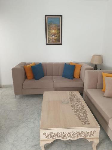 a living room with a couch and a coffee table at Two bedrooms appart in the heart of sousse in Sousse