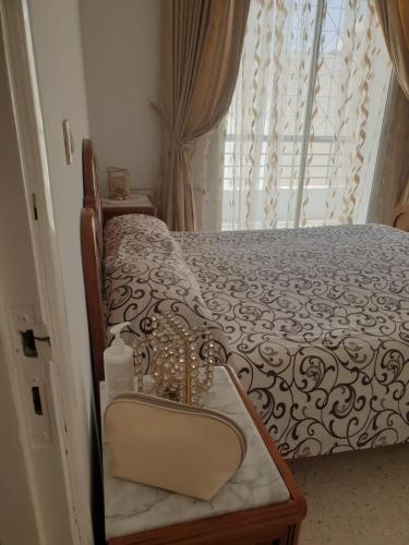 a bedroom with a bed with a mirror and a window at Two bedrooms appart in the heart of sousse in Sousse