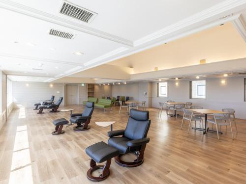 a large room with chairs and tables and tables at Hotel Wing International Shizuoka in Shizuoka